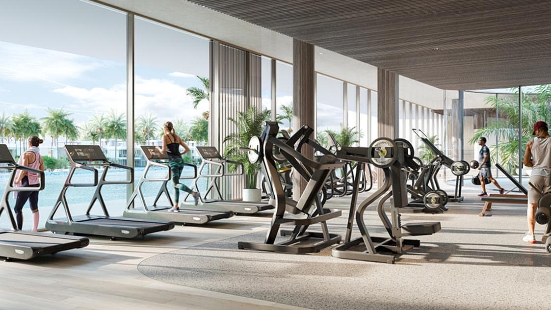 The indoor fitness area at Yas Riva Reserve, looking out over the water